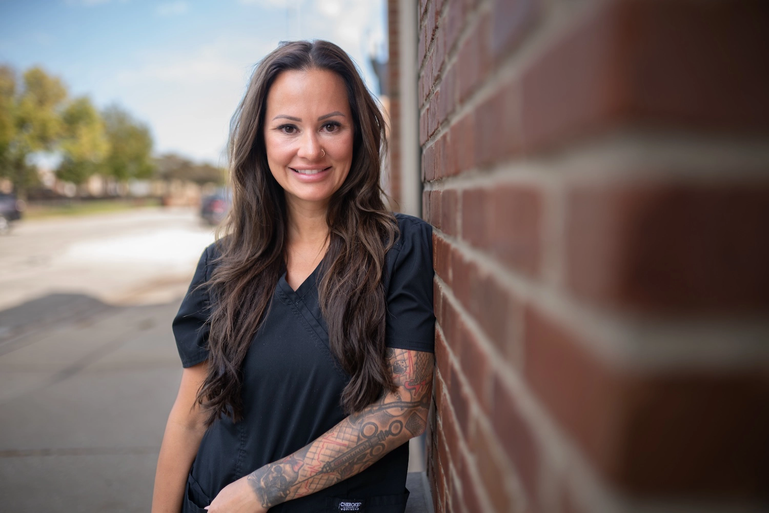 Stefanie Drozd, RN-BSN, standing outside Express Med Spas' Frankfort, IL location in professional medical attire